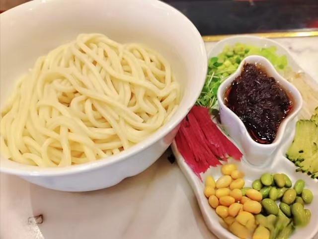 Traditional bowl of zhajiangmian noodles with toppings